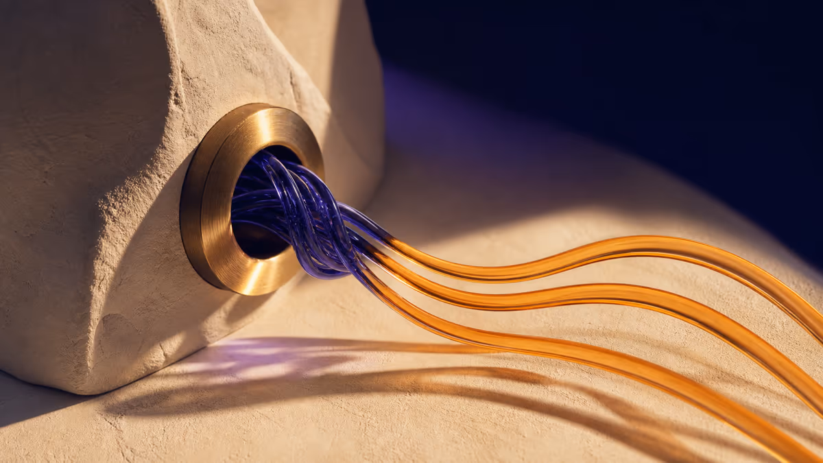 Tangled indigo glass becoming three clear amber ribbons in a sculptural studio scene