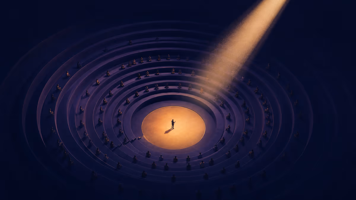 A speaker illuminated at the center of a circular indigo amphitheater